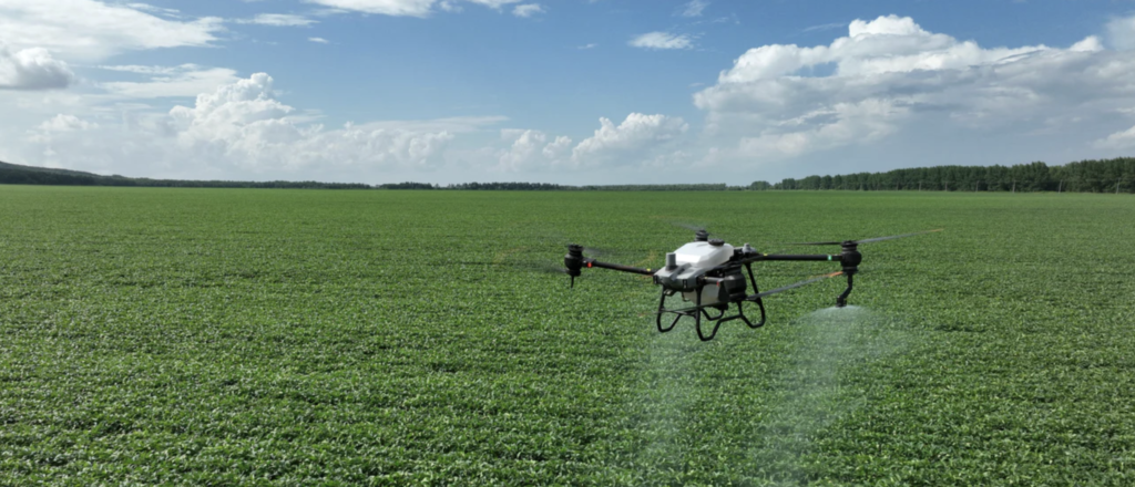 DJI drone spraying chemical application on crops